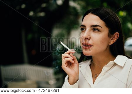Young Couple Of Man And Woman Smoking Cigarette Together