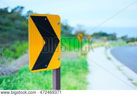 A Row Of Arrows Warns Drivers About A Curve In The Road. High Quality Photo