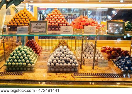 Craft Chocolate Bites A Lot On Shop Window, Store Shelf. Heap Of Assorted Chocolates. Candy Balls Of
