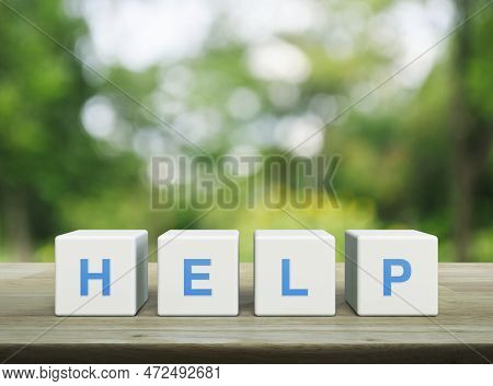 Help Letter On White Block Cubes On Wooden Table Over Blur Green Tree In Park, Business Customer Ser