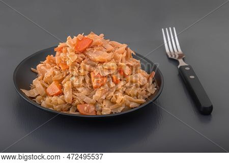 Stewed Cabbage - Bigos In A Black Plate On A Dark Background. Close-up