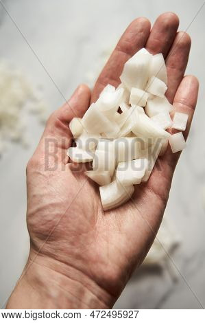Large Diced Onions On Mans Hand. Photo Show How Does Onion Sliced Into Large Cubes And Sliced And Di