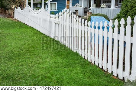 Nice White Wooden Fence Around House. Wooden Fence With Green Lawn. Street Photo, Nobody, Selective 