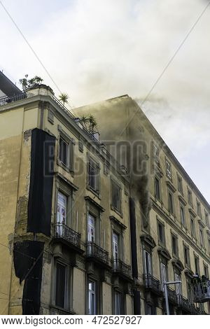 Editorial, Domestic Apartment Fire With Smoke Billowing From Window. Garibaldi Square, Naples, Italy
