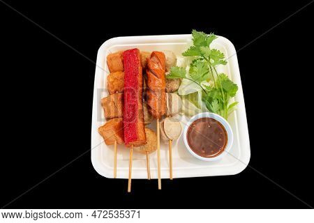 Isolated Thai Deep Fried Meatballs And Hotdog With Vegetable And Dipping Sauce On Black Background