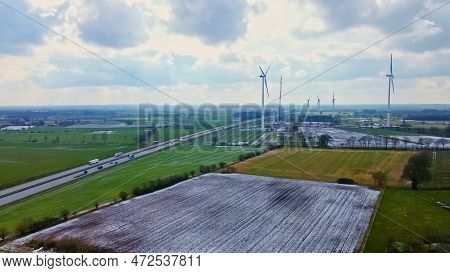 View From Above On The German Motorway A7 With Some Windmills For Renewable Electricity Under Constr