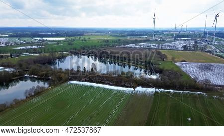 View From Above On The German Motorway A7 With Some Windmills For Renewable Electricity Under Constr