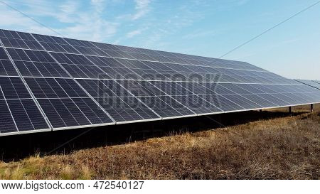 Solar Power Plant. Flight Over Modules Of Solar Power Station On Sunny Day. Alternative Green Electr