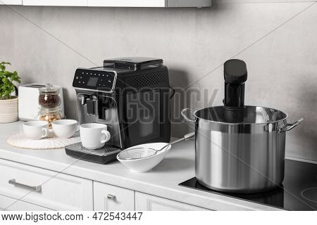 Pot With Sous Vide Cooker In Kitchen. Thermal Immersion Circulator