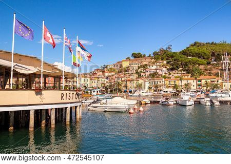 Porto Azzurro Island Of Elba Italy - 19 September 2021 Cityscape Of Harbor Of Porto Azzurro