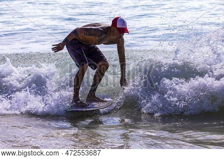 Playa Del Carmen, Mexico - March 12, 2023: Surfer Surfing The Waves Of The Caribbean Sea With His Sm