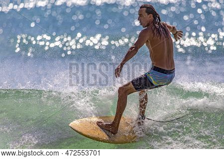 Playa Del Carmen, Mexico - March 12, 2023: Athletic Man Surfing The Waves Of The Caribbean Sea With