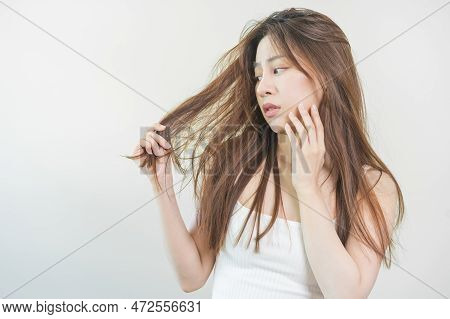 Damaged Hair, Frustrated Asian Young Woman, Girl Hand In Holding Splitting Ends, Messy Unbrushed Dry