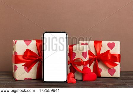 Mobile Phone With Blank Screen On Colored Background With Hearts, Calendar And Gift Box, Valentine D