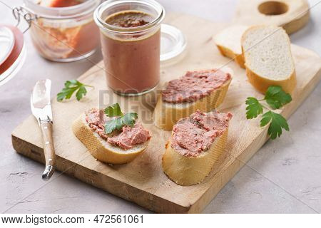 Homemade Chicken Liver Pate On Fresh French White Wheat Baguette Slices On Wooden Board, Glass Mason