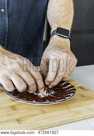 One Man Serving Slices Of Iberic Ham On A Plate. Spanish Traditional Jamon
