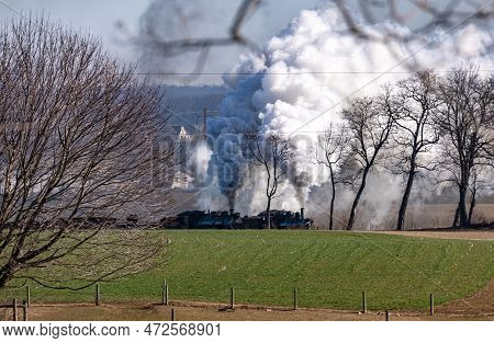 A View Of A Steam Double Header Freight Train Traveling Thru Rural America Blowing Lots Of Smoke And