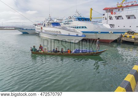 Sorong, Indonesia - February 02, 2023: Passengers In A Long Boat At The Pier In Sorong, Ships At The