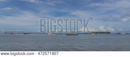 View From The Ferry To Waisai At Sorong With Cruises And Tour Boats, Background Blue Sky, Copy Space
