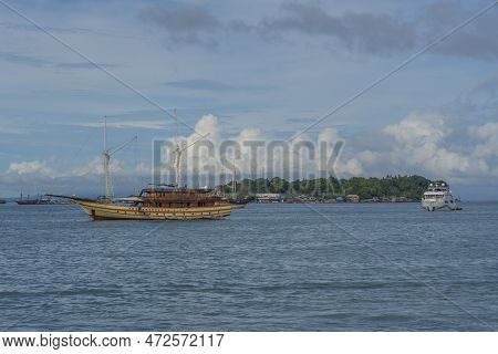 View From The Ferry To Waisai At Sorong With Cruises And Tour Boats, Background Blue Sky, Copy Space
