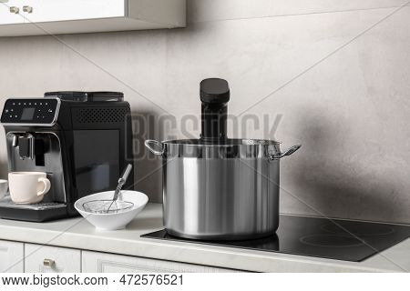 Pot With Sous Vide Cooker In Kitchen. Thermal Immersion Circulator