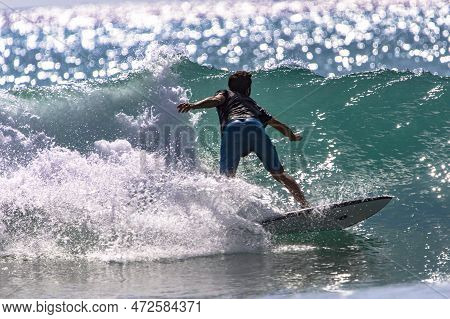 Playa Del Carmen, Mexico; March 13, 2023: Person Surfing With His Board Along The Crest Of The Waves