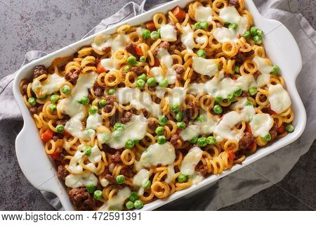 Homemade Anelli Gratin With Cheese, Ground Beef, Vegetables Close-up In A Baking Dish On The Table. 