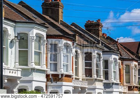 A Row Of Typical English Terraced Houses Around Kensal Rise In London With Overhead Cable Lines
