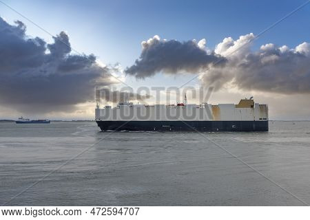 Cargo Ship Cruises In Front Of The Beach At Boulevard Evertsen In Vlissingen. Provinz Zeeland In The