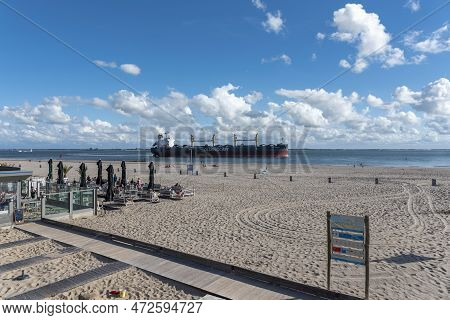 Cargo Ship Cruises In Front Of The Beach At Boulevard Evertsen In Vlissingen. Provinz Zeeland In The