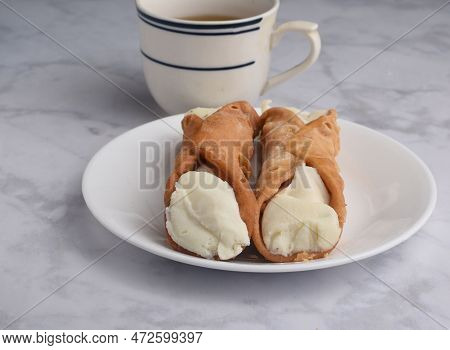 Two Cannolis Filled With Ricotta  Served With Green Tea,