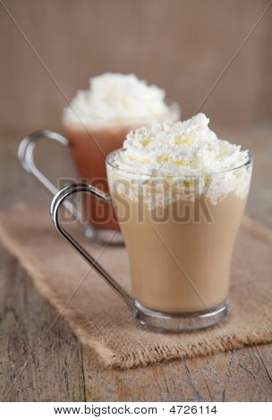 Coffee Latte And Hot Chocolate With Whipped Cream On Old Wooden Table