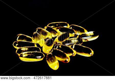 Fish Oil Capsules On A Dark Background.