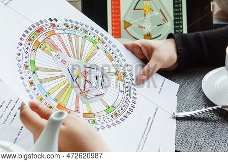 Tver, Russia - February 12, 2023: A Woman At The Table Is Studying A Rave Mandala By Human Design. R