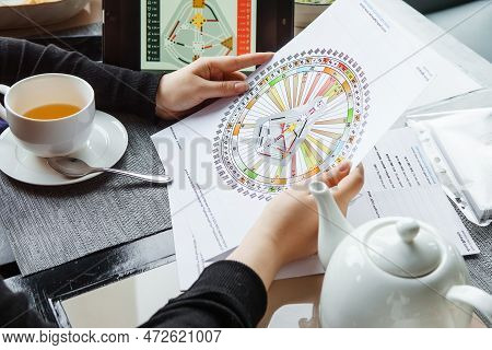 Tver, Russia - February 12, 2023: A Woman At The Table Is Studying A Rave Mandala By Human Design. R
