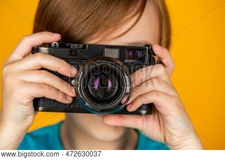 Child In Studio With Professional Camera. Boy Using A Cameras. Baby Boy With Camera. Cheerful Smilin