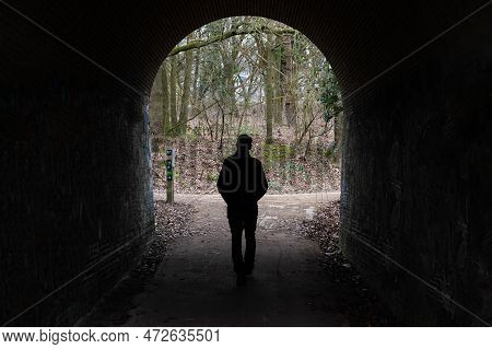 Uccle, Brussels Capital Region, Belgium, March 4, 2023 - Lonely Man Walking Under An Arched Bridge