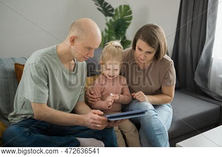 Deaf Child Girl With Cochlear Implant Studying To Hear Sounds And Have Fun With Mother And Father - 