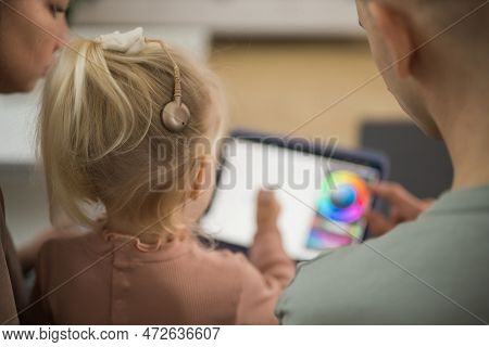 Deaf Child Girl With Cochlear Implant Studying To Hear Sounds And Have Fun With Mother And Father - 