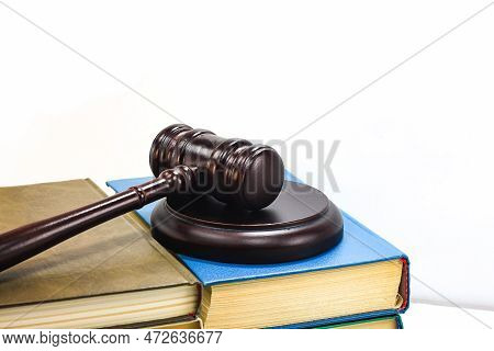 Abstract Photo With Wooden Gavel And Books With Codes On White Background As Symbol Of Of Rule Of La