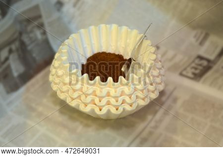 A Coffee Filter Is Loaded With A Mound Of Ground Coffee, Ready To Be Brewed Into A Fresh Cup Of Joe