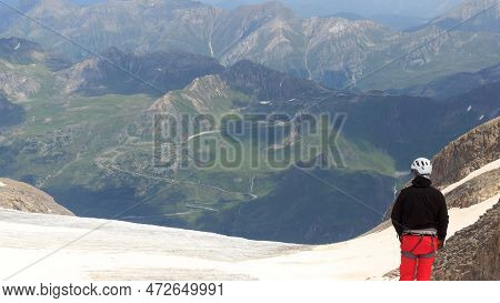 Mountaineer Standing On Glacier And Looking Towards Grossglockner High Alpine Road And Mountain Pano