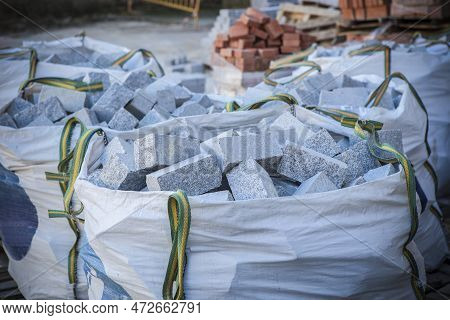 Raffia Large Sack Full Of Granite Cobblestones. Construction Material Concept