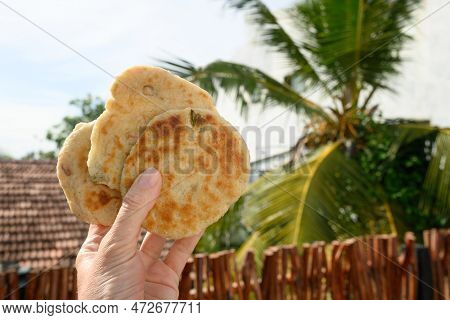 Authentic Sri Lankan Three Pol Coconut Roti In Hand.