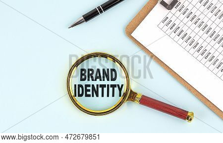 Brand Identity Text On A Magnifier With Clipboard On Blue Background