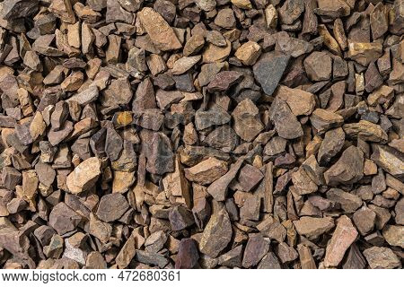 Closeup Image Of Background Made Of Pile Of Colorful Brown, Yellow And Red Crushed Stones.