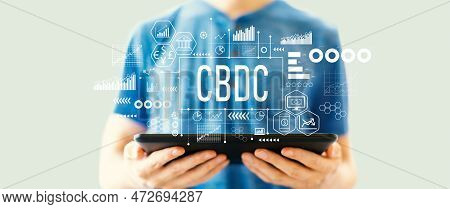 Cbdc - Central Bank Digital Currency Concept With Young Man Using A Tablet Computer