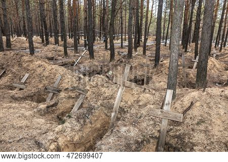 Izium, Ukraine - Mar. 03, 2023: Crosses Are Seen At A Forest Grave Site After An Exhumation In The T