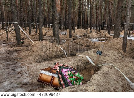 Izium, Ukraine - Mar. 03, 2023: Some Of The Victims Were Buried In Coffins With Flower Arrangements 