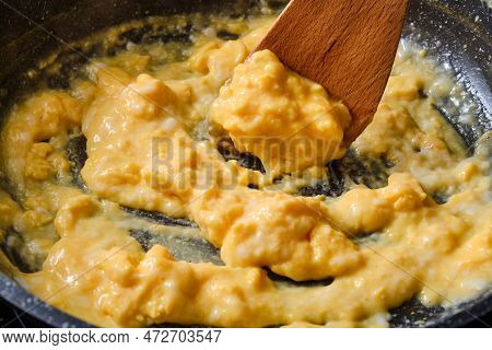 Preparing Stasty Crambled Eggs On Cooking Pan